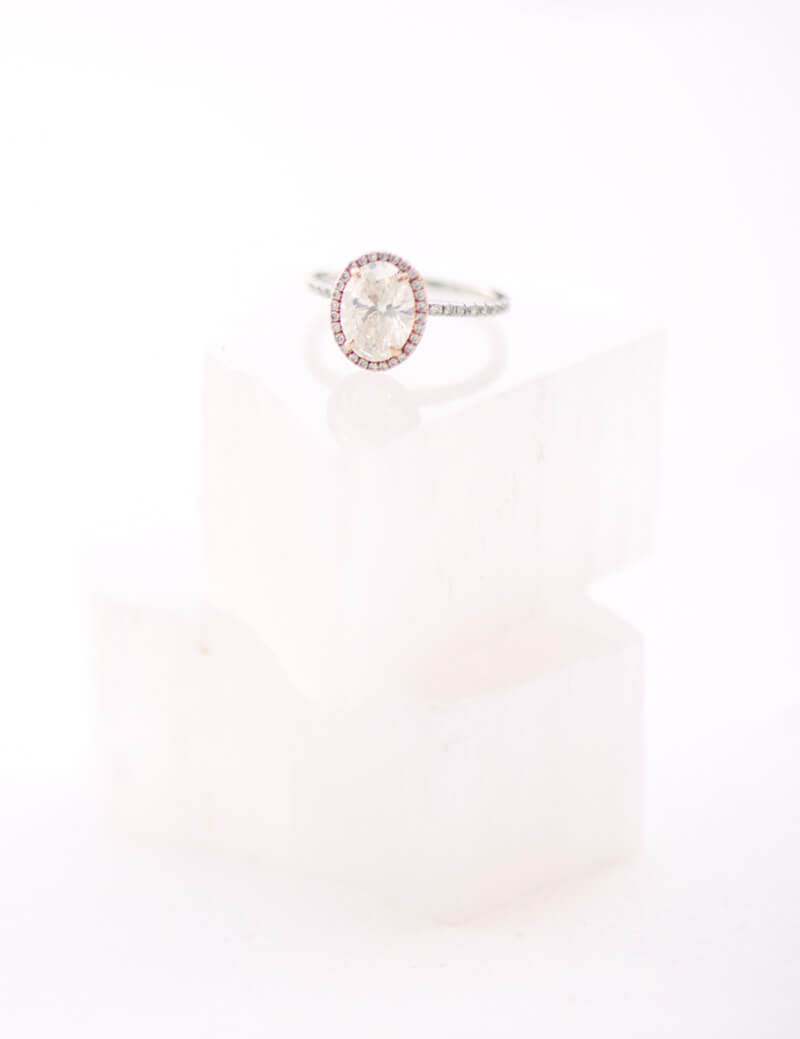Oval Halo Diamond Engagement Ring – Ideal Jewelers About Us Oval halo diamond engagement ring on white display blocks Ideal Jewelers About Us Frederick MD